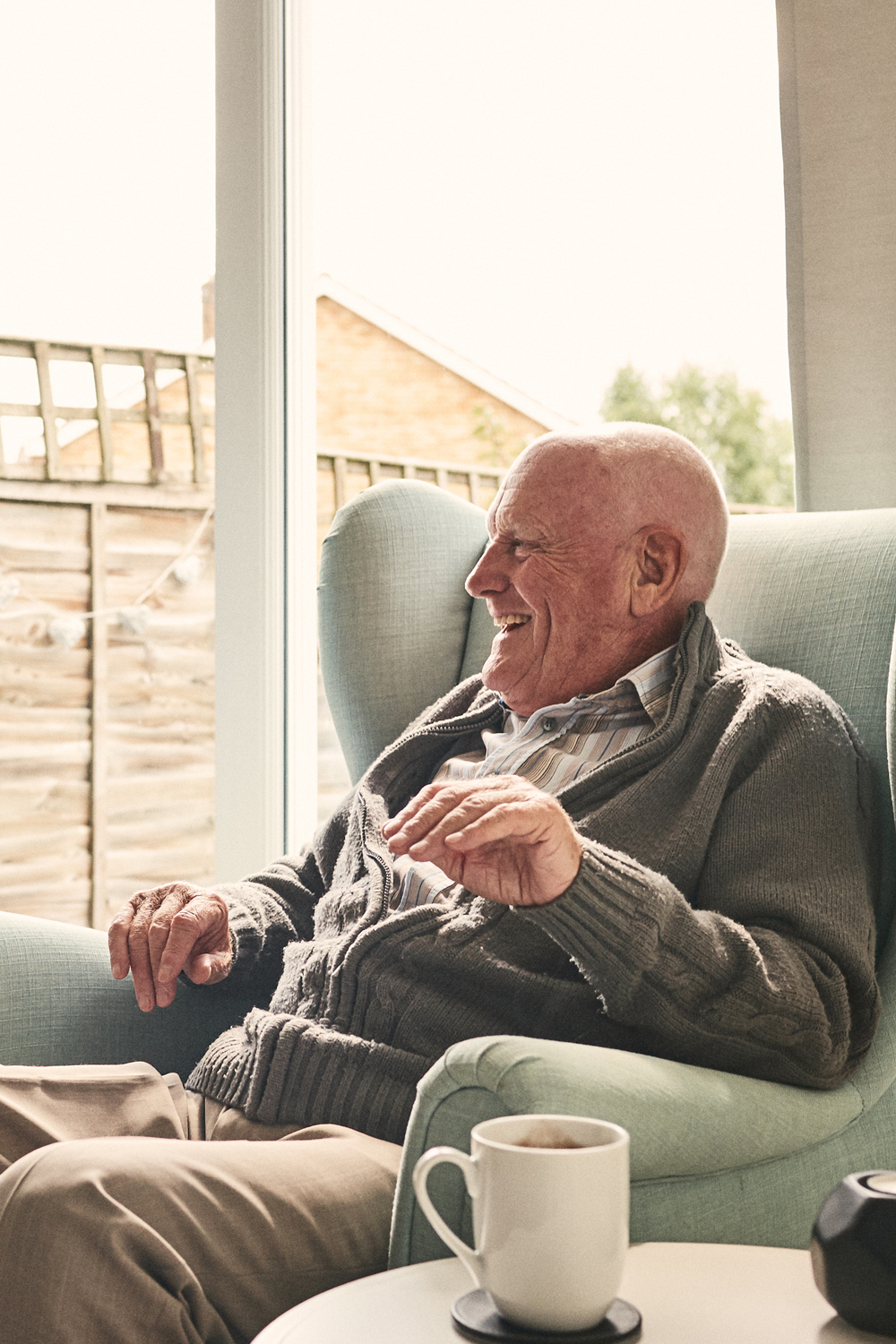 Smiling senior man in lounge chair